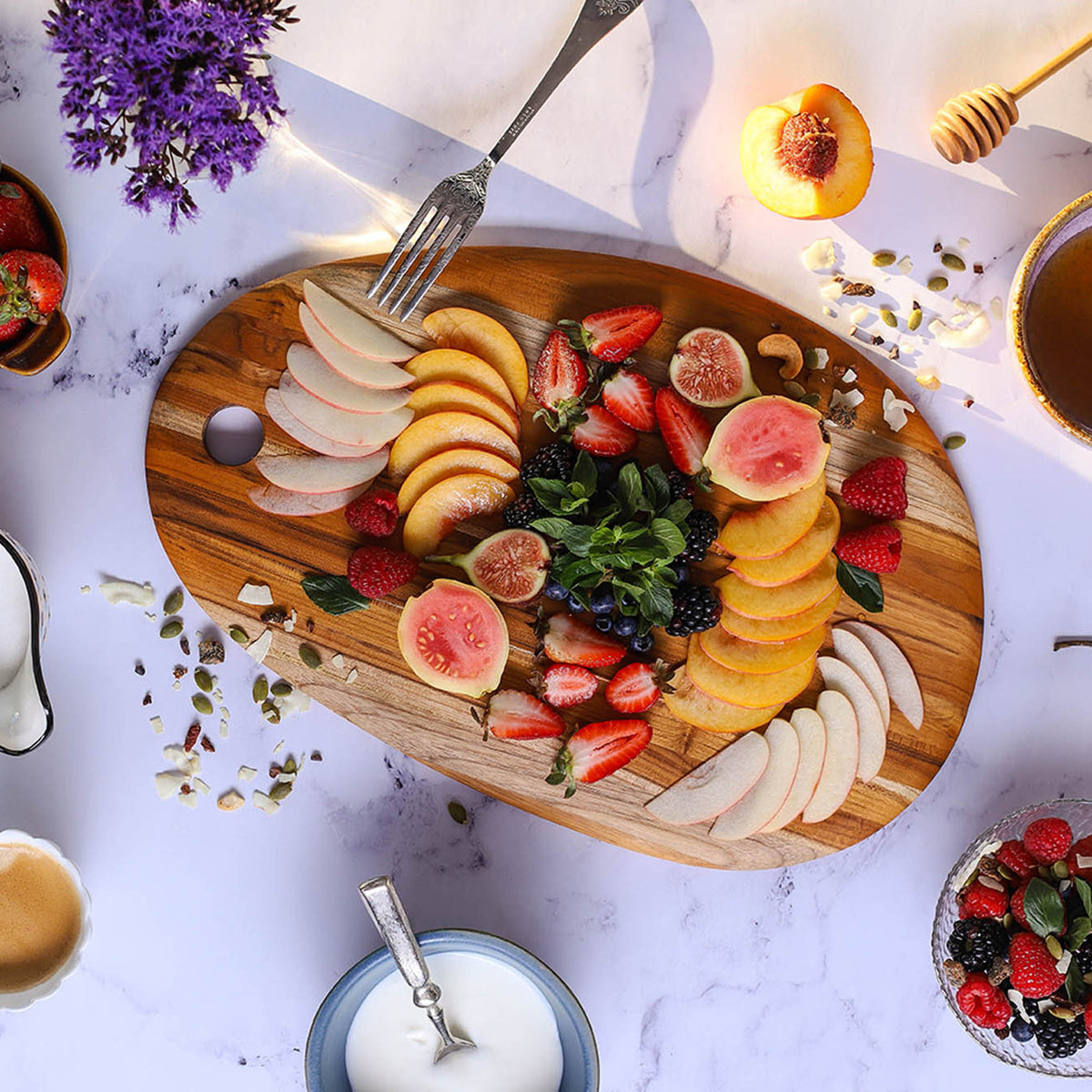 Oval TEAKHAUS teak wood cutting board with smooth surface and natural wood grain for kitchen use