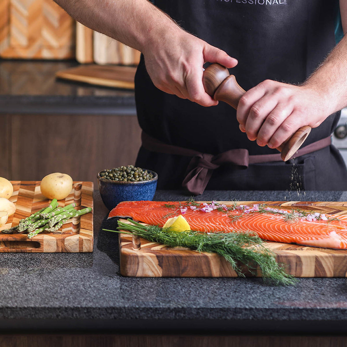 TEAKHAUS teak wood cutting board with herringbone pattern, suitable for kitchen prep and serving, made from durable teak wood.