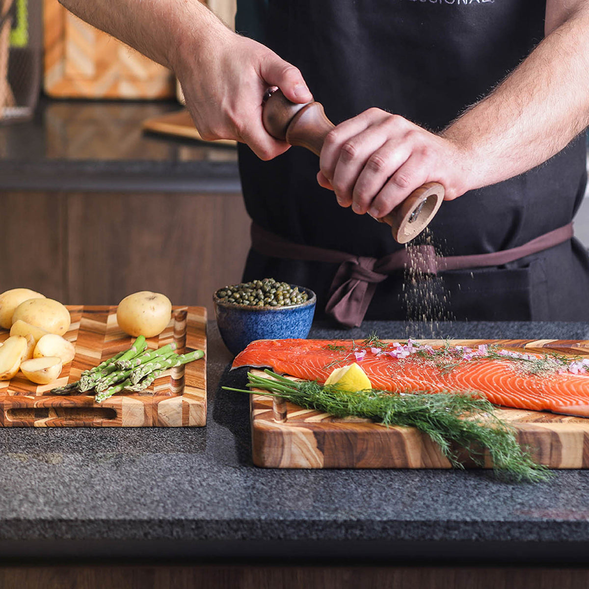 Teakhaus teak wood cutting board with herringbone pattern, ideal for food prep and serving.