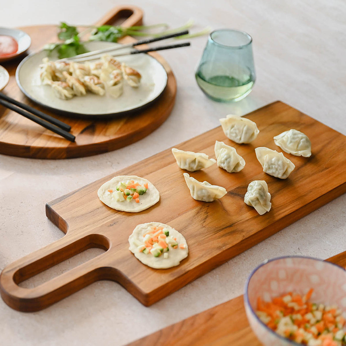 Teakhauss teak wood cutting board with bistro style design, rectangular shape, and smooth finish for kitchen use.