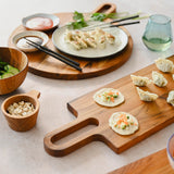 Teakhaus teak wood cutting board with bistro design, natural finish perfect for food prep and serving.
