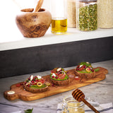 BÉRARD olive wood cutting board, long rectangular shape with natural wood grain and smooth finish.