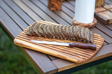 BÉRARD brown bread cutting board with 1.5 cm thickness, made of wood, on a kitchen countertop.
