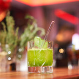 Clear PROFINO glass drinking straw, reusable and transparent, shown coiled on a white background.