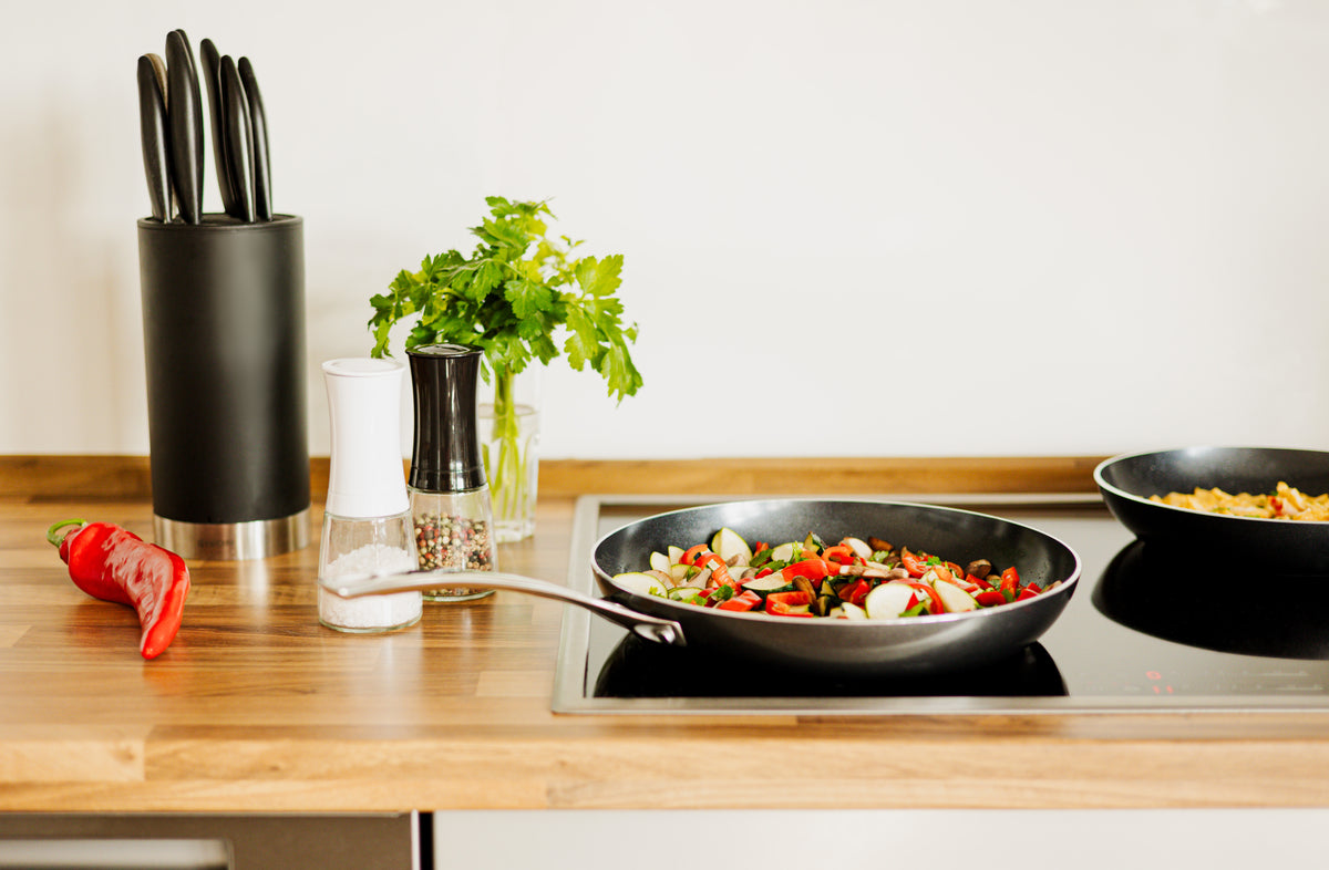 Kyocera ceramic frying pan in black with non-stick surface and ergonomic handle, ideal for versatile cooking.