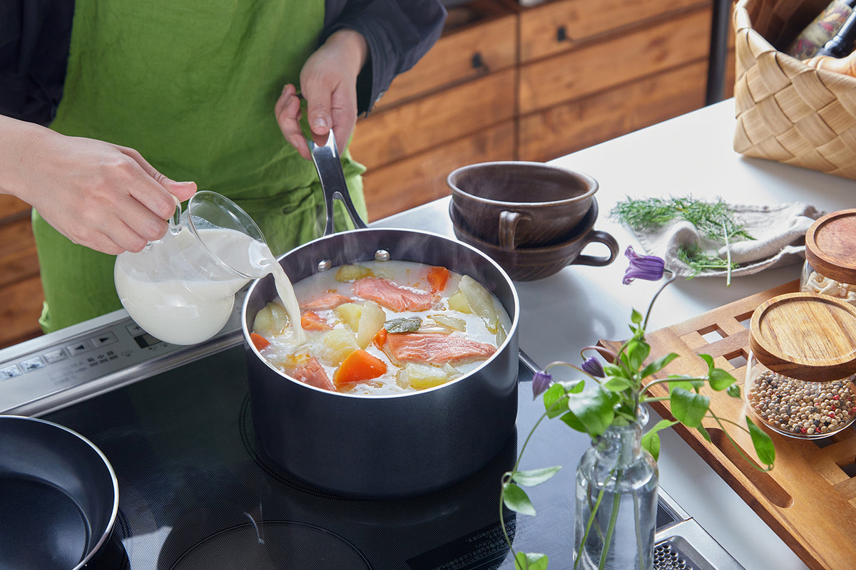 Kyocera ceramic black cooking pot showing its sleek, durable ceramic surface and sturdy handles for versatile kitchen use.