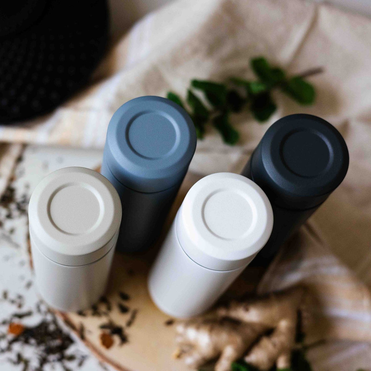 White KYOCERA SLIM MUG insulated bottle with a sleek, slim design and secure lid, ideal for hot or cold beverages.