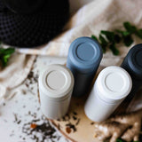 KYOCERA slim beige 300ml insulated bottle with lid, compact and sleek design for hot or cold drinks.