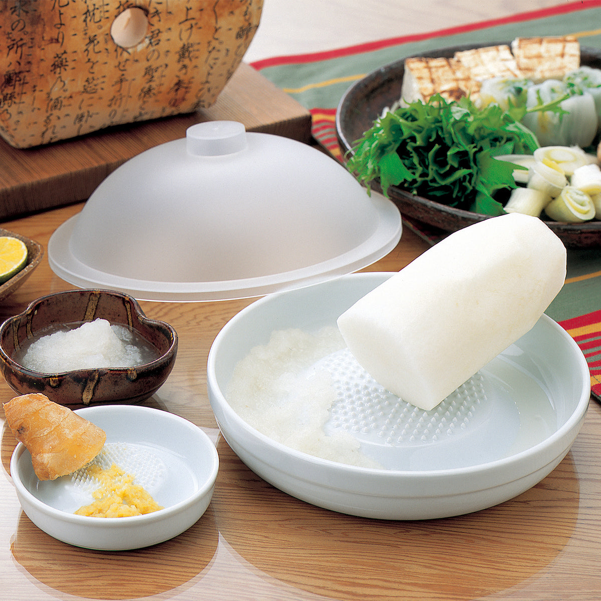 White KYOCERA ceramic grater with a sleek design, ideal for grating cheese, vegetables, and spices.