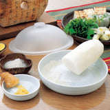 White KYOCERA ceramic grater with a sleek design, ideal for grating cheese, vegetables, and spices.