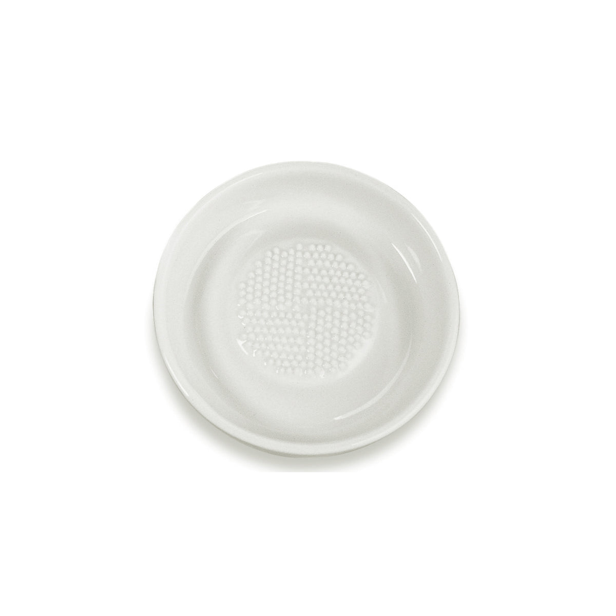 White ceramic grater by KYOCERA, showcasing its smooth surface and sharp edges for efficient food grating and zesting.
