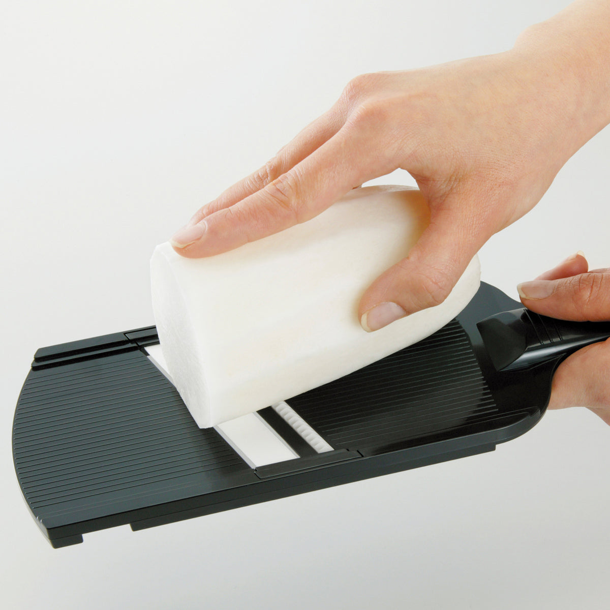 Black KYOCERA julienne vegetable peeler with ergonomic handle and stainless steel blade for precise julienne cuts.