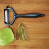 KYOCERA double-sided green vegetable peeler with sharp blades, designed for efficient peeling of fruits and vegetables.