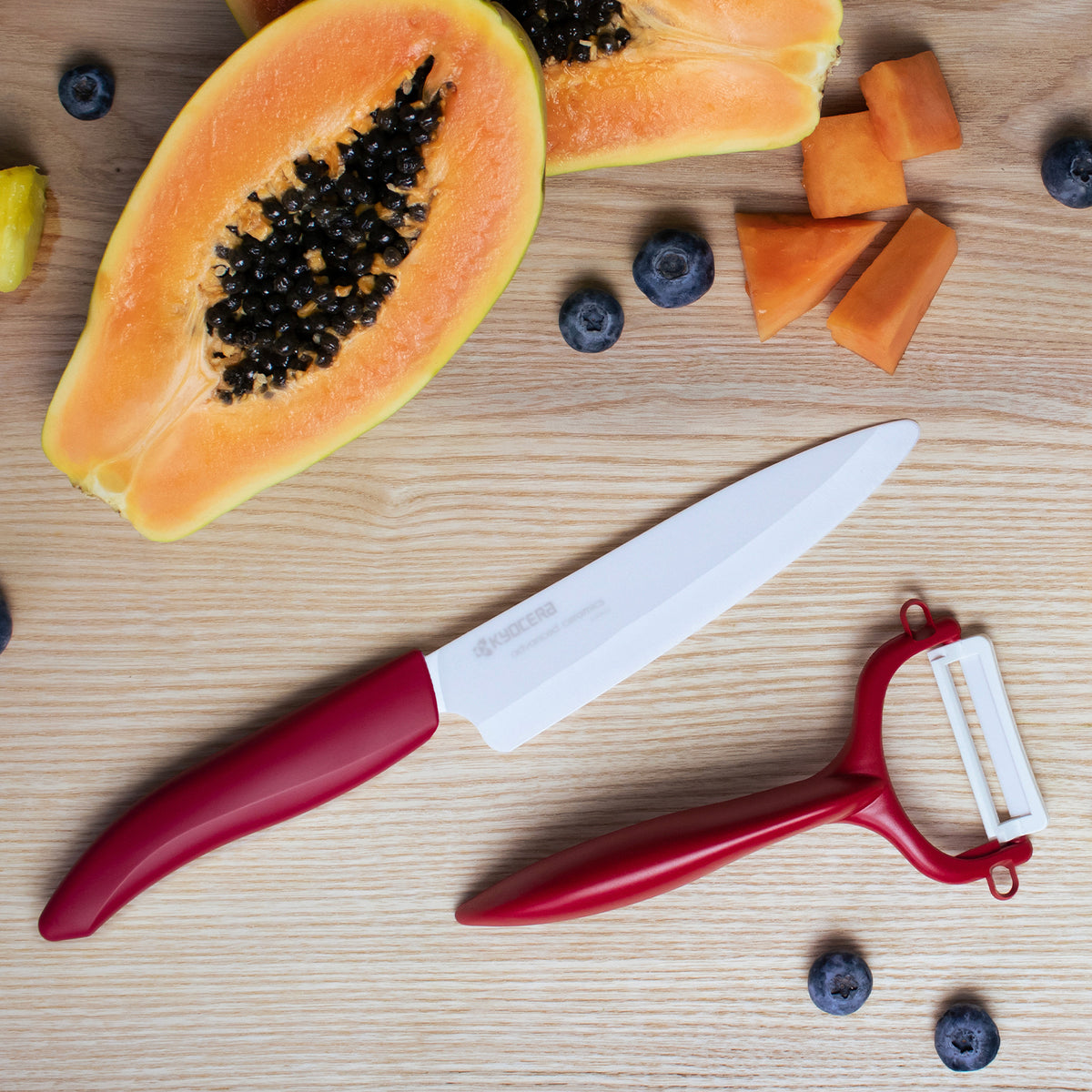 KYOCERA double-sided green vegetable peeler with sharp, dual blades for efficient peeling and slicing.