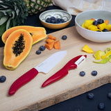 KYOCERA ceramic knife in red with a sleek blade and ergonomic handle, designed for precise slicing and cutting.