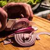 Black KYOCERA ceramic knife with sleek handle and blade, ideal for precise cutting and slicing in the kitchen.