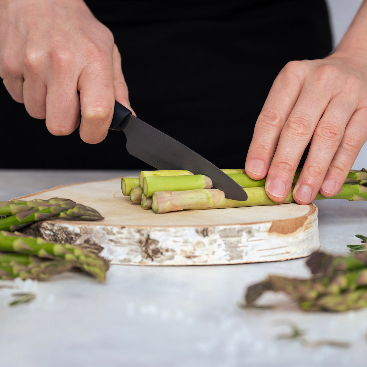KYOCERA ceramic knife with black handle and blade, lightweight and sharp kitchen tool for precise cutting.