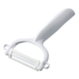 KYOCERA double-sided green vegetable peeler with sharp blades and ergonomic handle, designed for peeling fruits and vegetables.