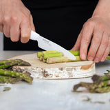 KYOCERA ceramic paring knife with white handle and blade, designed for precise cutting and kitchen prep.