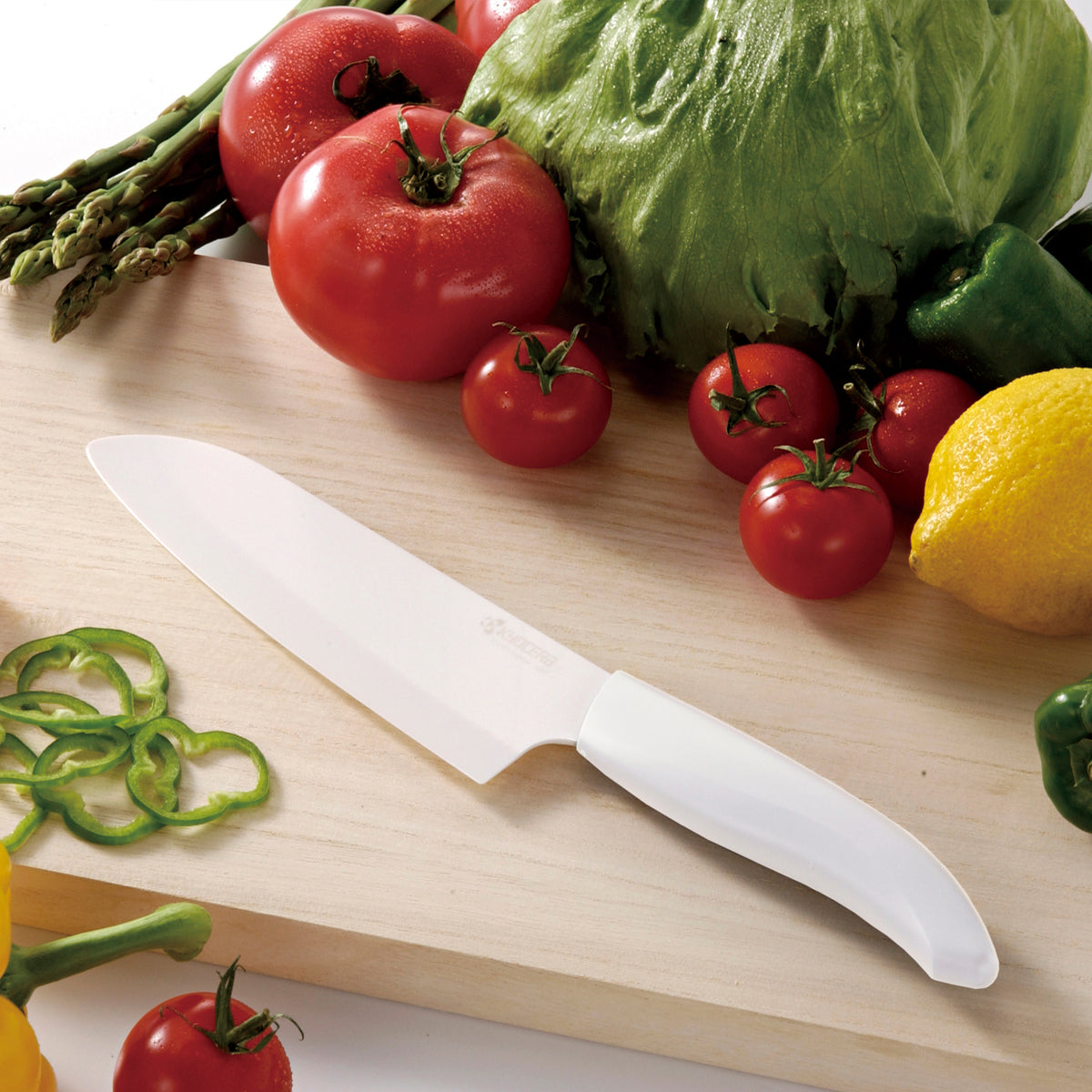 KYOCERA ceramic peeling knife with white handle and sharp blade, ideal for precision peeling and kitchen prep.