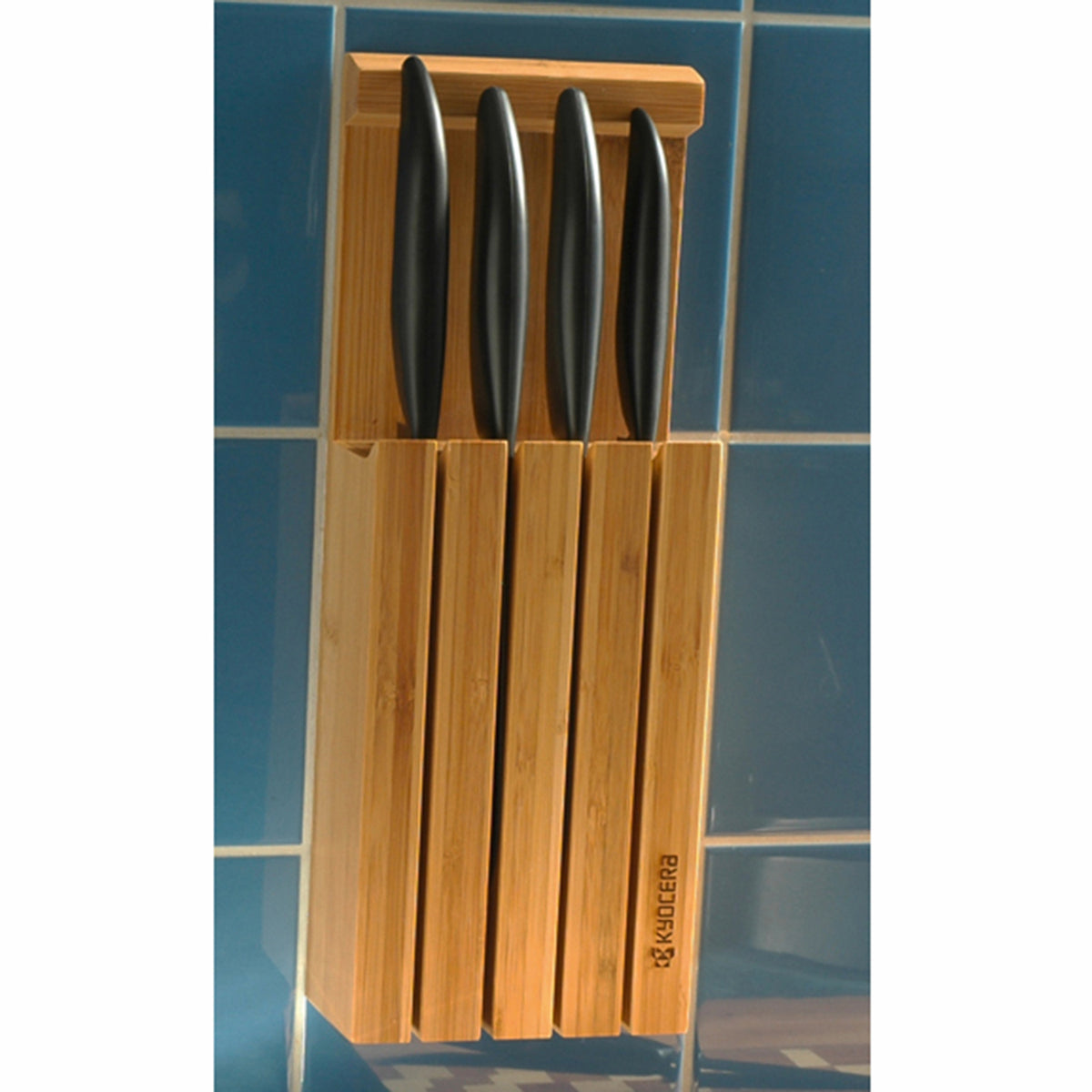 Kyocera 3-in-1 bamboo knife block with multiple slots for storing kitchen knives and utensils, modern and functional design.