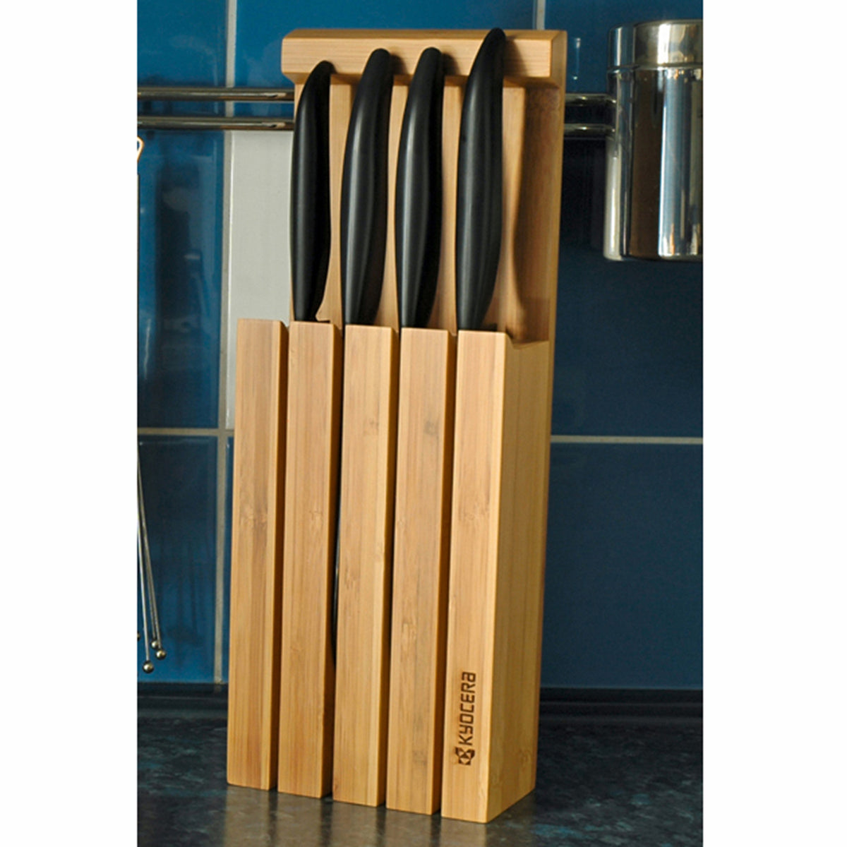 KYOCERA 3-in-1 bamboo knife block with multiple slots for storing and organizing kitchen knives and utensils.