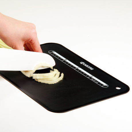 Kyocera flexible black cutting mat, 37 x 25 cm, ideal for precise slicing and crafting applications.