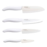 KYOCERA Messerblock with four white ceramic knives and bamboo stand, showcasing sleek kitchen knife storage and cutting tools.