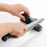 KYOCERA manual knife sharpener with two sharpening slots, compact and easy to use for kitchen knives.