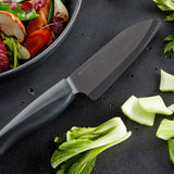 Kyocera SHIN black ceramic knife with sleek handle, perfect for precise slicing and cutting in the kitchen.