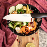 KYOCERA GEN NATURE black ceramic knife with a sleek handle and sharp blade, ideal for precise cutting and culinary use.