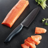 KYOCERA SHIN black ceramic knife with sleek handle and sharp blade, ideal for precise slicing and kitchen use.