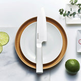 KYOCERA white ceramic knife with a sleek handle, ideal for precision cutting and kitchen prep.