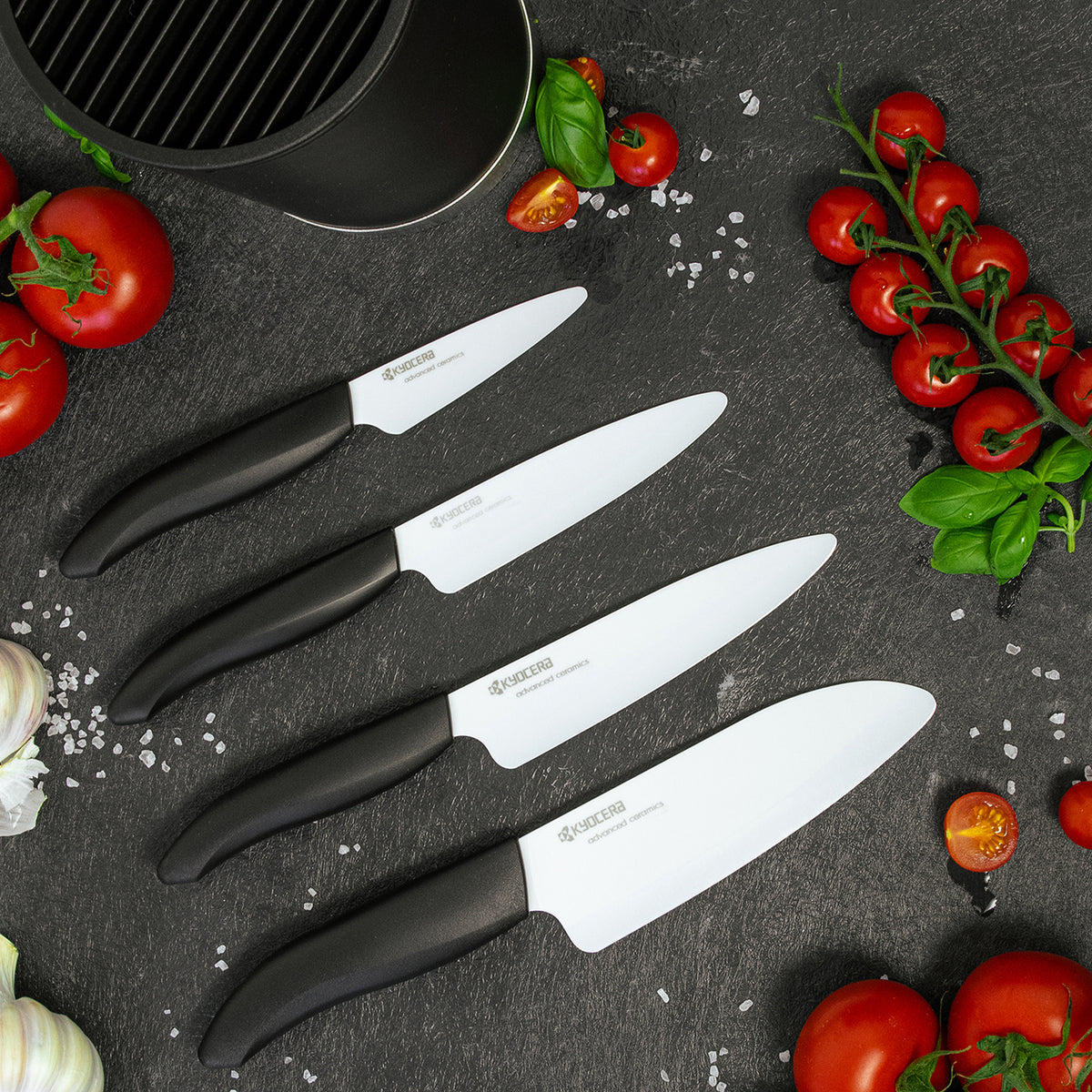 KYOCERA knife block with four GEN soft-touch knives, showcasing sleek black design and safety features.