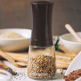 KYOCERA ceramic spice grinder in dark brown, 16 cm, with a sleek design and textured grip for easy seasoning.