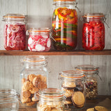 Clear Kilner Clip Square jar for preserving, with a metal clip lid and glass body, ideal for storing jams and homemade preserves.