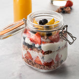 Clear KILNER Clip Square canning jar with metal clip lid, perfect for preserving fruits and vegetables.