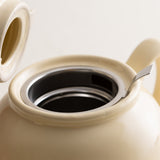 Cream-colored P & K Teekanne teapot with a sleek design, featuring the PRICE & KENSINGTON branding.