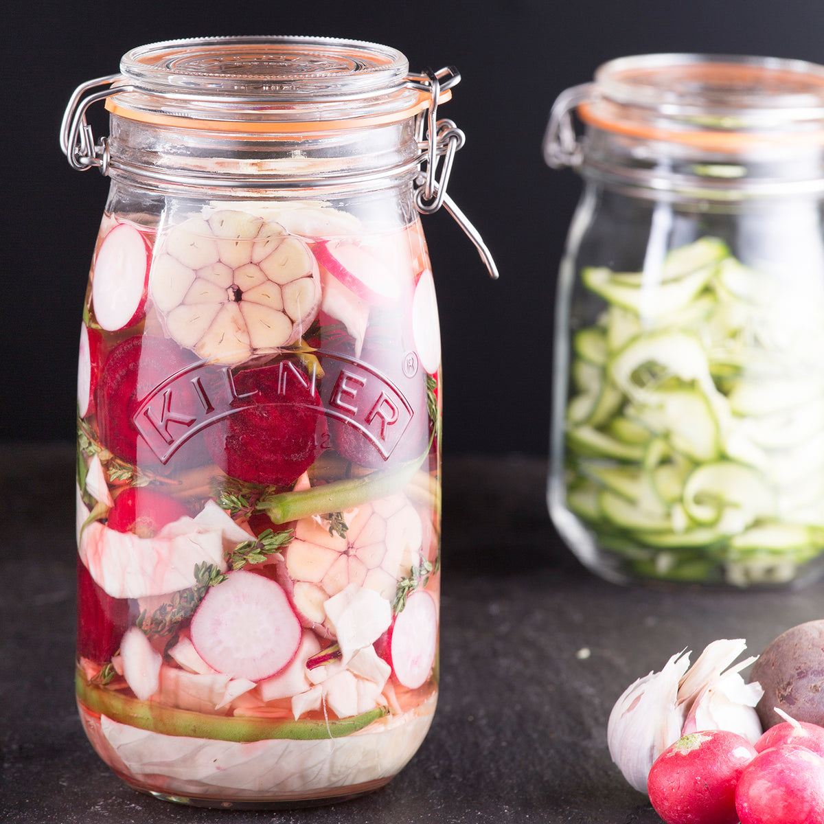 Clear Kilner clip round canning jar for preserving, with a metal clip lid and glass body, ideal for storing homemade foods.