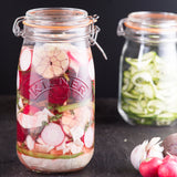 Clear Kilner clip round canning jar for preserving, with a metal clip lid and glass body, ideal for storing homemade foods.