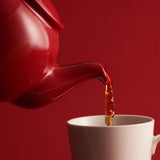 Red P & K PRICE & KENSINGTON Teekanne with a classic round shape and handle, designed for brewing tea.