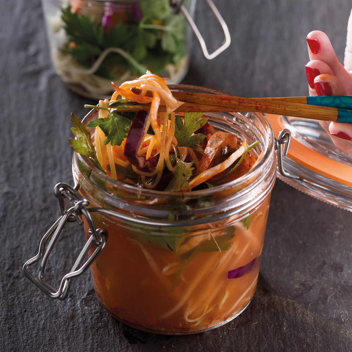 Clear KILNER Clip Round canning jar with metal lid for preserving foods, shown in a close-up image.