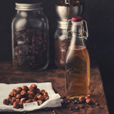 Clear KILNER Einkochflasche Clip Square for preserving liquids, made of durable glass with a secure clip lid.