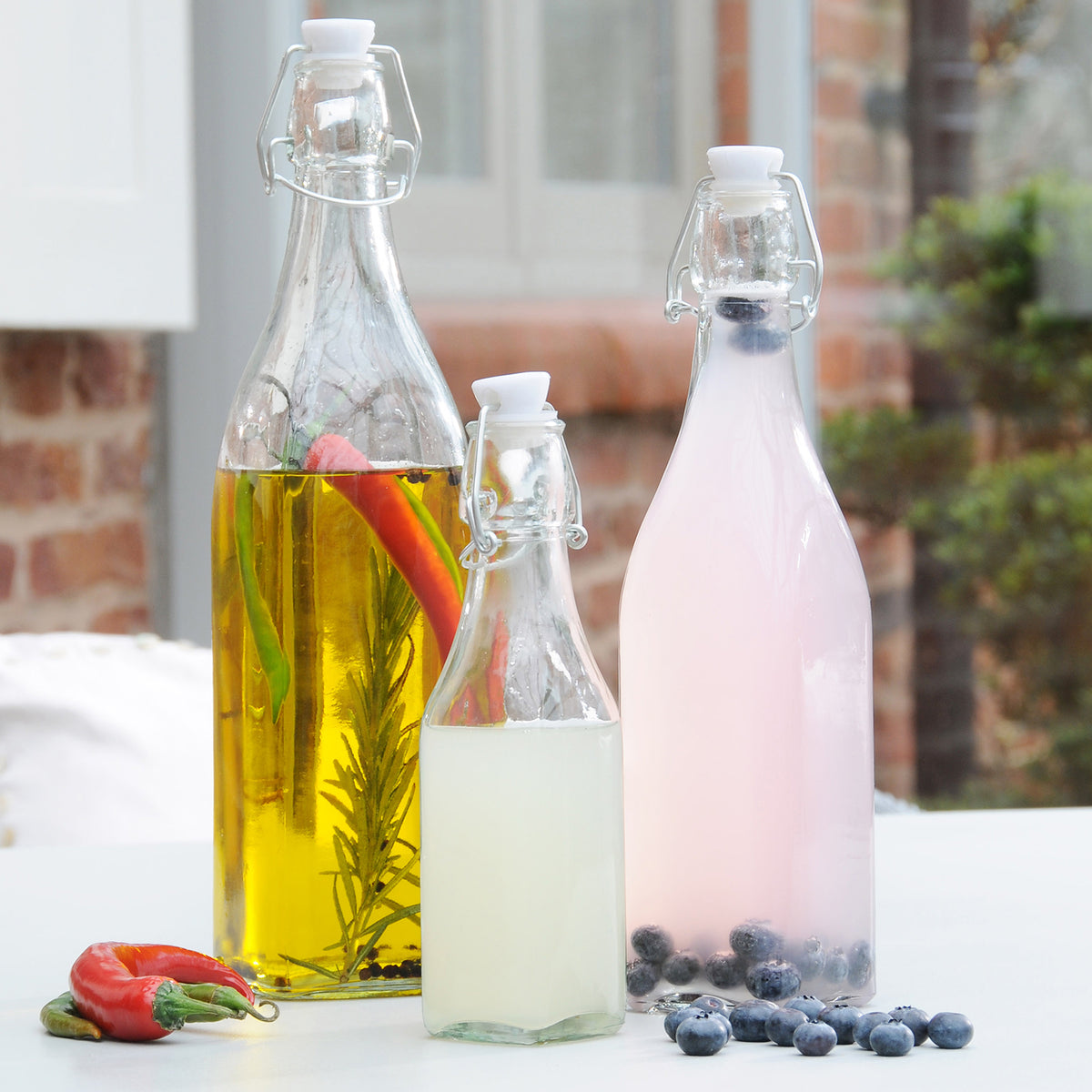 Clear Kilner clip square canning jar for preserving food, with metal clip closure and wide mouth for easy filling.