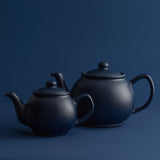 Blue P & K PRICE & KENSINGTON teapot with a curved handle and spout, featuring a glossy finish and elegant design.