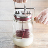Kilner 1L clear butter churn with wooden lid and handle, traditional butter making jar with glass body and metal clasp.