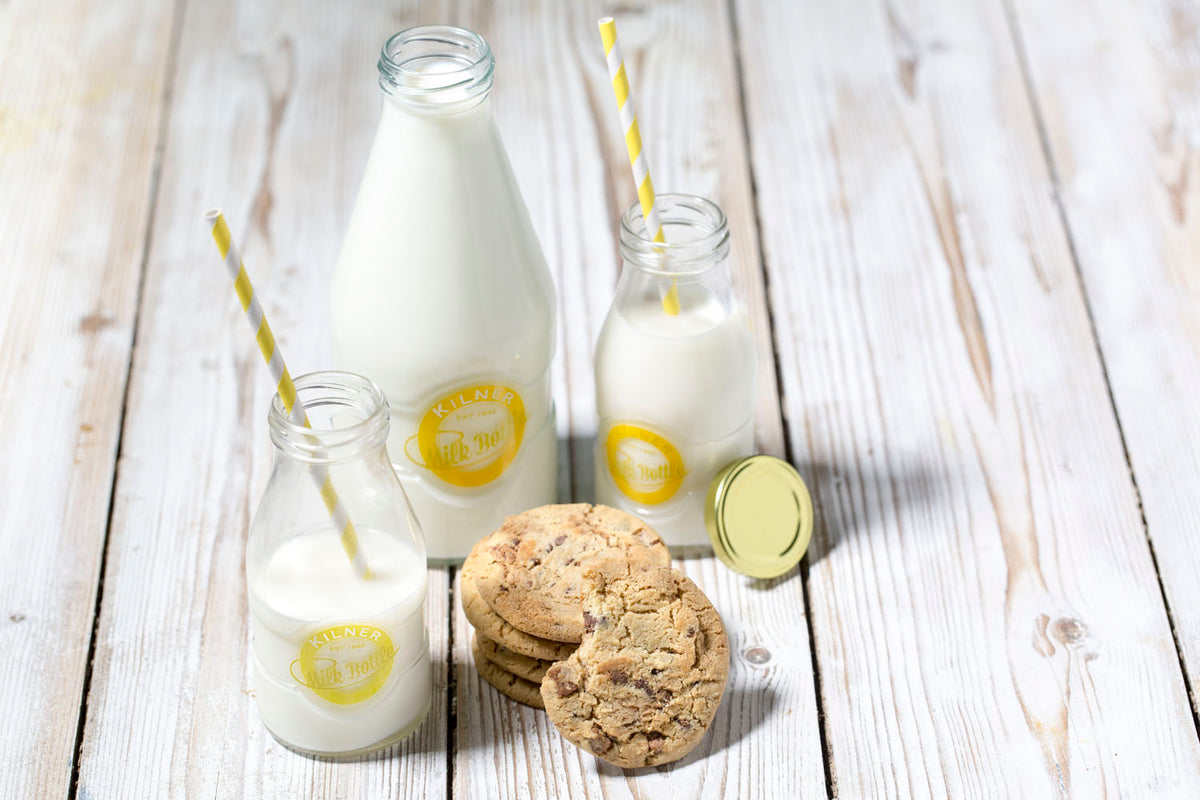 KILNER glass milk bottle with a clear, cylindrical design and screw-top lid, suitable for storing and serving milk.