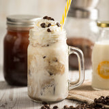 KILNER manual coffee grinder with crank, clear glass body, 500 ml capacity, showing the hand crank and coffee beans inside.