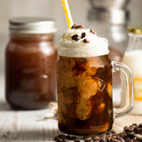 KILNER manual coffee grinder with crank and clear glass body, 500 ml capacity, showing the hand crank and glass container.