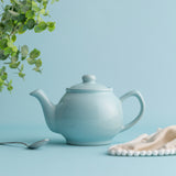 Blue P & K Price & Kensington teapot with two matching cups displayed on a white background.